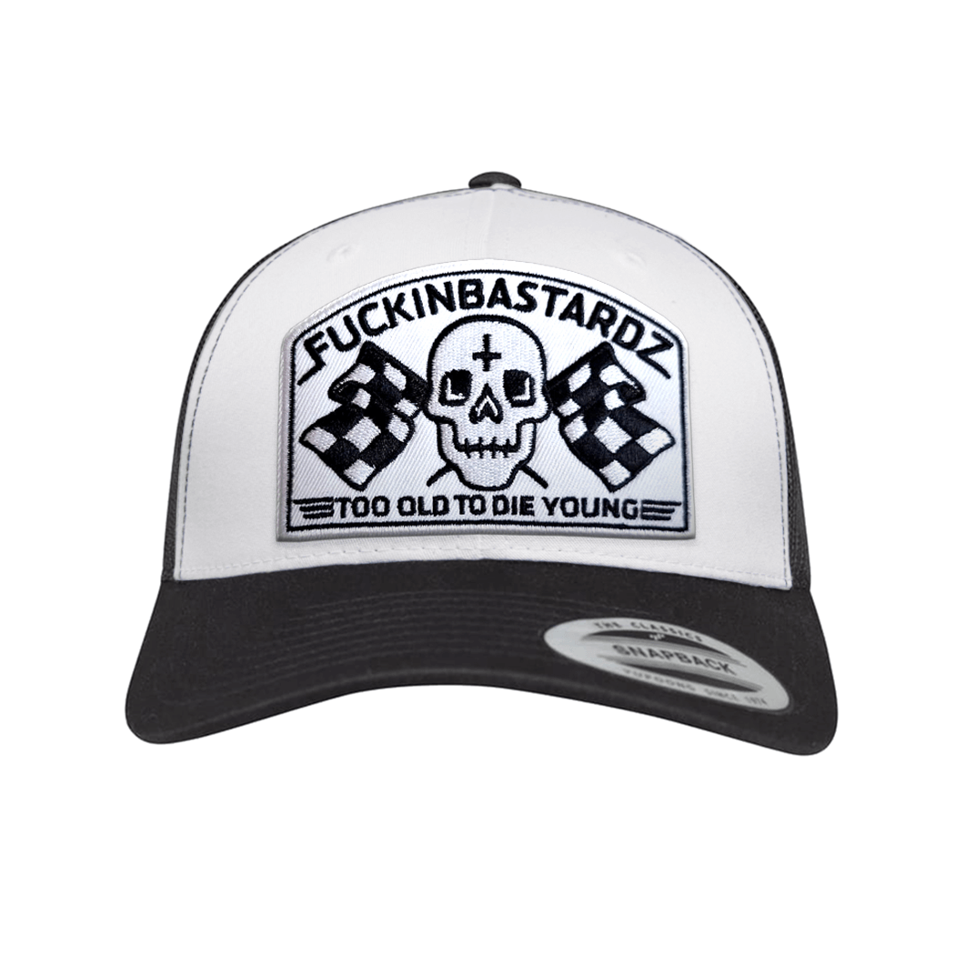 Die Old Trucker Cap with embroidered patch featuring a skull and checkered flags.