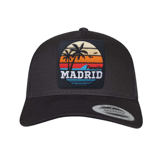 Madrid Paradise trucker cap featuring embroidered patch with palm trees and sunset design.